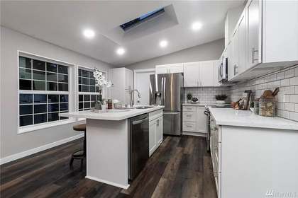 Kitchen remodel — white cabinets, dark hardwood